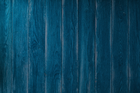 Dark blue wood texture with natural patterns. Background for design. Vintage wooden blue vertical boards. Front view with copy space.の写真素材
