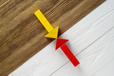 Two arrows pointing to each other. Two wooden arrows red and yellow.の写真素材