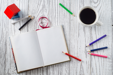 Notepad, pencils and coffee on wooden table. Top view, flat lay. Concept of creative work,  design.の写真素材