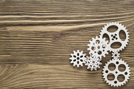 Gear wheels on wooden background. The concept of creative, logical thinking.の写真素材