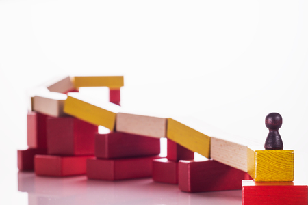 Abstract man on top of a wooden construction, the concept of a career competition, career ladder, business learning success, business hierarchy. Achieving success. Social status, business metaphor.の写真素材