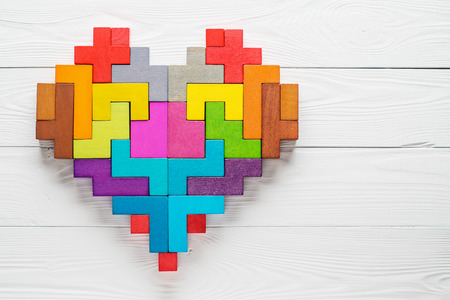 Heart made of colorful wooden shapes, top view, flat lay. Health background concept.