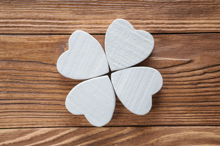 Abstract clover on wood background, top view, flat lay.  Abstract white wooden clover, close-up.の写真素材