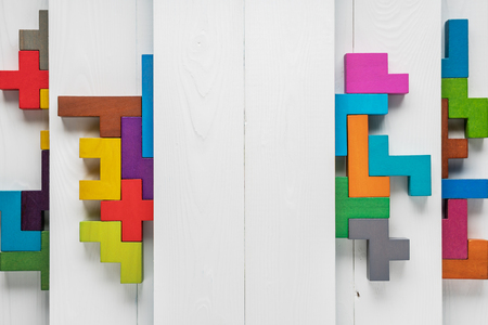 Different colorful shapes wooden blocks on wooden background with copy space, top view.の写真素材