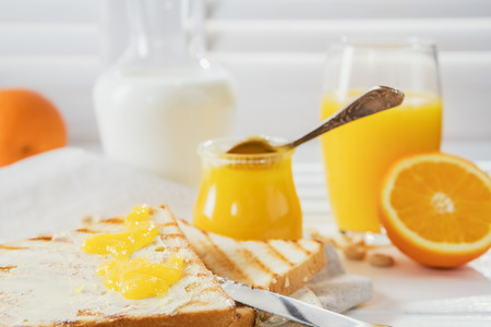 Delicious breakfast, french toasts with butter and honey, fresh oranges and juice.の写真素材