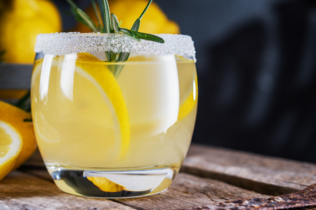 Lemon cocktail on dark rustic background, close-up.の写真素材