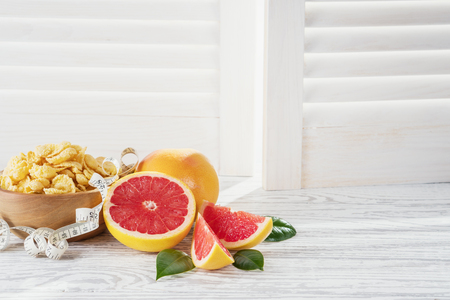 Ripe grapefruits on rustic white wooden background.の写真素材