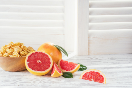 Ripe grapefruits on rustic white wooden background, close-up.の写真素材