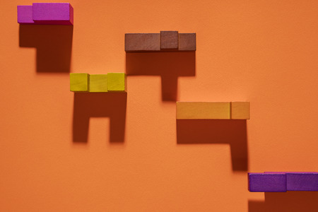 Abstract geometric background, colorful logic game. Isometric game blocks on orange background.の写真素材