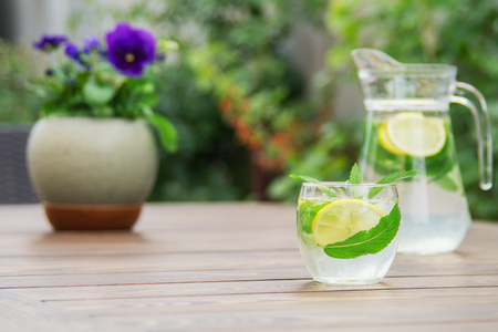 Fresh homemade lemonade with ice and mint on the table with copy space.の写真素材