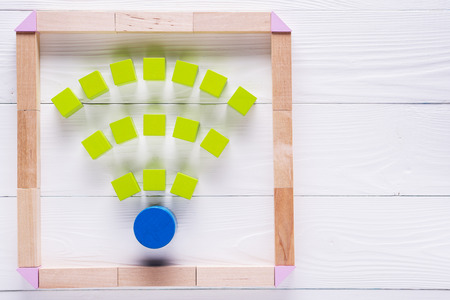 Wi fi sign from green wooden blocks on the white background.の写真素材