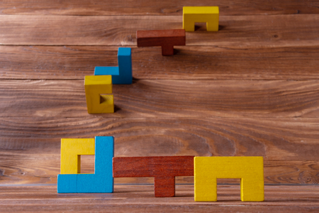 Abstract Background. Different colorful shapes wooden blocks on white wooden background. Geometric shapes in different colors. Copy space.の写真素材