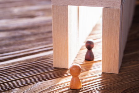 Abstract people into the wooden corridor with copy space. Concept of success. Two persons walk to the light in the tunnel.の写真素材