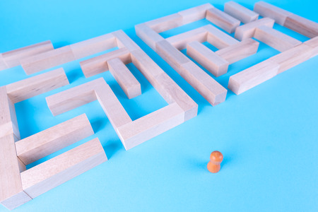 People in the maze, finding a way out. The man in the maze. The concept of a business strategy, analytics, search for solutions, the search output. Labyrinth of wooden blocks.の写真素材