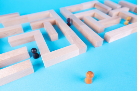 People in the maze, finding a way out. The man in the maze. The concept of a business strategy, analytics, search for solutions, the search output. Labyrinth of wooden blocks.の写真素材