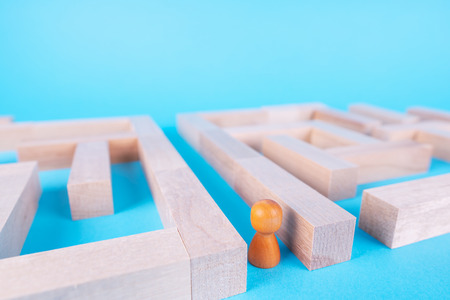 People in the maze, finding a way out. The man in the maze. The concept of a business strategy, analytics, search for solutions, the search output. Labyrinth of wooden blocks.の写真素材