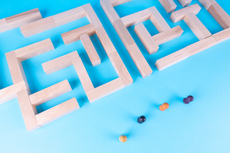 People in the maze, finding a way out. The man in the maze. The concept of a business strategy, analytics, search for solutions, the search output. Labyrinth of wooden blocks.の写真素材