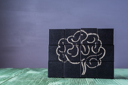 The concept of the human brain. Education, science and medical concept.  Brain drawn in chalk on black cubes.の写真素材