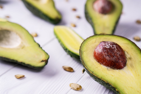 Avocado, cucumber, lime, pumpkin seeds on a white wooden table, healthy food. Healthy lifestyle...