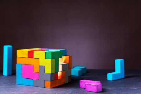 Cube of multi-colored wooden shapes. Concept of decision making process, creative, logical thinking. Choose correct answer. Logical tasks. Conundrum, find the missing piece of the proposed.の写真素材