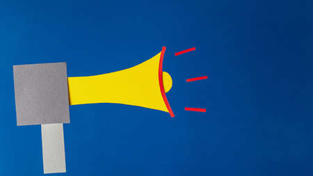 Megaphone on blue background, flat lay. Marketing and advertising concept, paper art.の写真素材