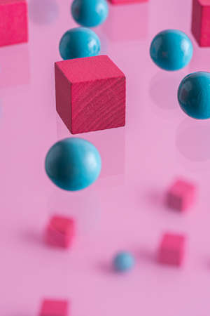 Pink boxes and blue spheres, abstract background.の写真素材