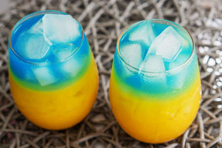 Blue and yellow cocktails like the flag of Ukraine. Two patriotic cocktails, victory concept. Close up, top viewの写真素材