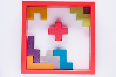 Top view on colorful wooden blocks folding on white wooden background