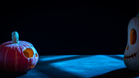 Two Halloween pumpkins in the moonlight on black background.の写真素材