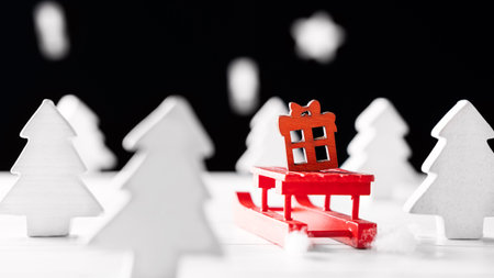 Christmas background with white Christmas trees, snow and red sleighの写真素材