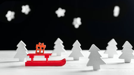 Christmas background with white Christmas trees, snow and red sleighの写真素材