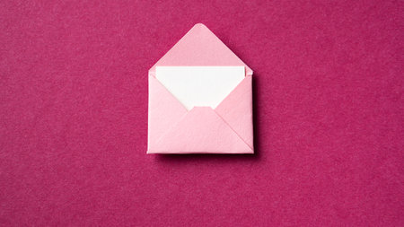 Blank white card with pink paper envelope template mock up on dark pink backgroundの写真素材