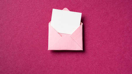 Blank white card with pink paper envelope template mock up on dark pink backgroundの写真素材