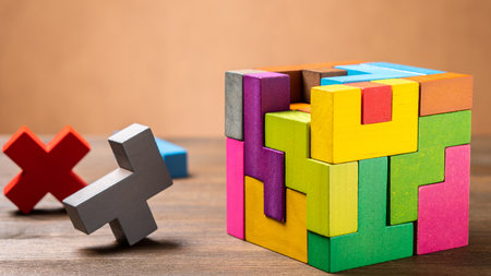 The wooden cube is made of colorful wooden shapes. Geometric shapes in different colors. Logical tasks. Conundrumの写真素材