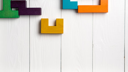 Top view on colorful wooden blocks folding on white wooden backgroundの写真素材