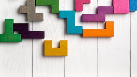 Top view on colorful wooden blocks folding on white wooden backgroundの写真素材