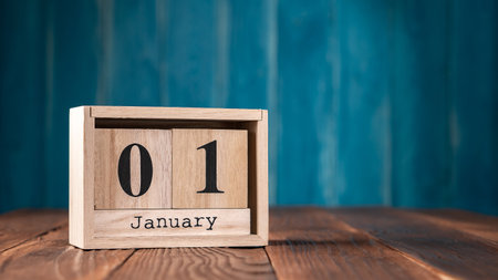 January First wooden vintage calendar on dark blue background with copy spaceの写真素材