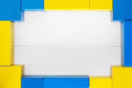 Blue and yellow wooden frame on a white background with space for text. copyspace.の写真素材