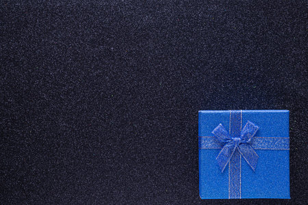 Blue gift box on glitter black background with copy space. close up. top view. Xmas, Valentines day or birthday party concept. greeting card, frame. flat lay. copy spaceの写真素材