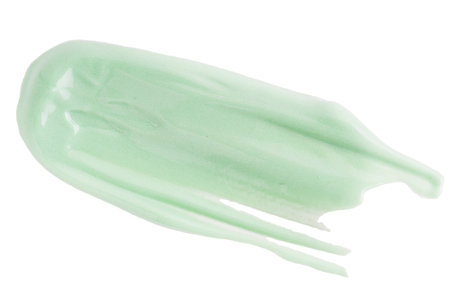 Cosmetic light green cream blob swatch on white background. Pastel green face cream stroke, makeup primer, color correcting cosmetic product, serumの写真素材