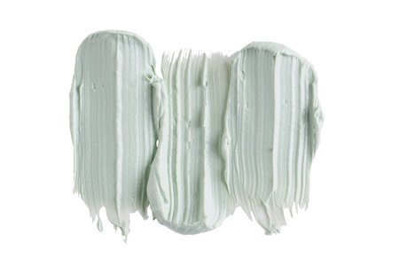 Green clay mask or correcting concealer smear smudge isolated on white background. Cream texture. Facial mask, skincare beauty product swatch closeup. SPA backgroundの写真素材