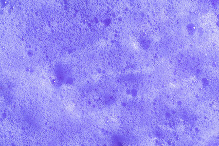 Purple hair shampoo foam. Violet lavender foaming soap closeup. Foam texture background. Macroの写真素材