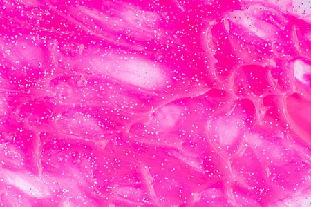 Pink glitter background. Beauty makeup product. Abstract art background, texture of glittering liquid paintの写真素材