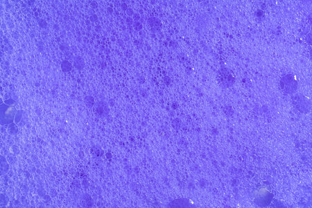 Purple foam. Violet lavender foaming soap closeup. Foam texture background. Macroの写真素材