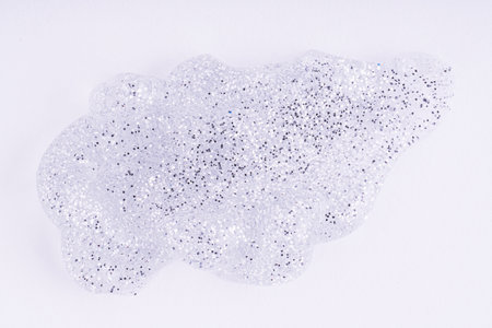 Cosmetic glittering gel swatch. Transparent shimmer silver cosmetic sample texture on white background. Cosmetic shiny face serum, lotion, moisturizer, beauty backgroundの写真素材