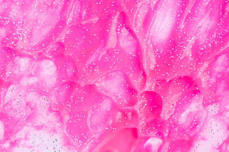 Pink glitter background. Beauty makeup product. Abstract art background, texture of glittering liquid paintの写真素材