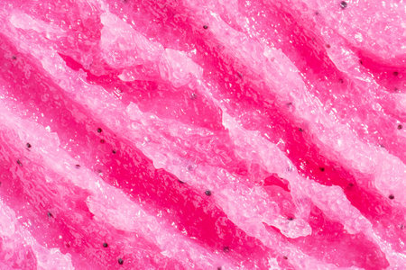 Pink scrub background. Strawberry scrub texture, cosmetics skincare, body peeling. Flat lay, top view. macroの写真素材