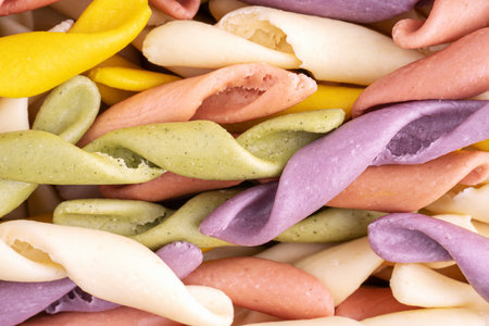 Strozzapreti Pasta, Italian traditional homemade pasta, macro shot, top view. Colorful Pasta, healthy food background. Multicolored Troffiette.の写真素材