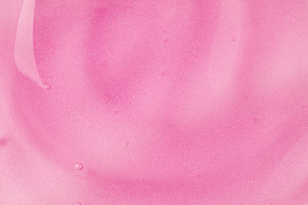 Pink gel fluid with bubbles, macro texture of cosmetics product. Cosmetic background.の写真素材