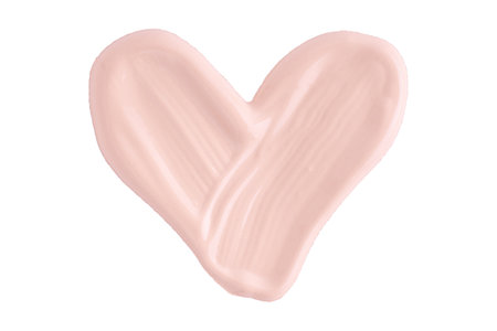 A smear of foundation cream or concealer in the shape of a heart isolated on white background, macro. Texture of cosmetic liquid foundation or beige cream smudge, smear, stroke.の写真素材